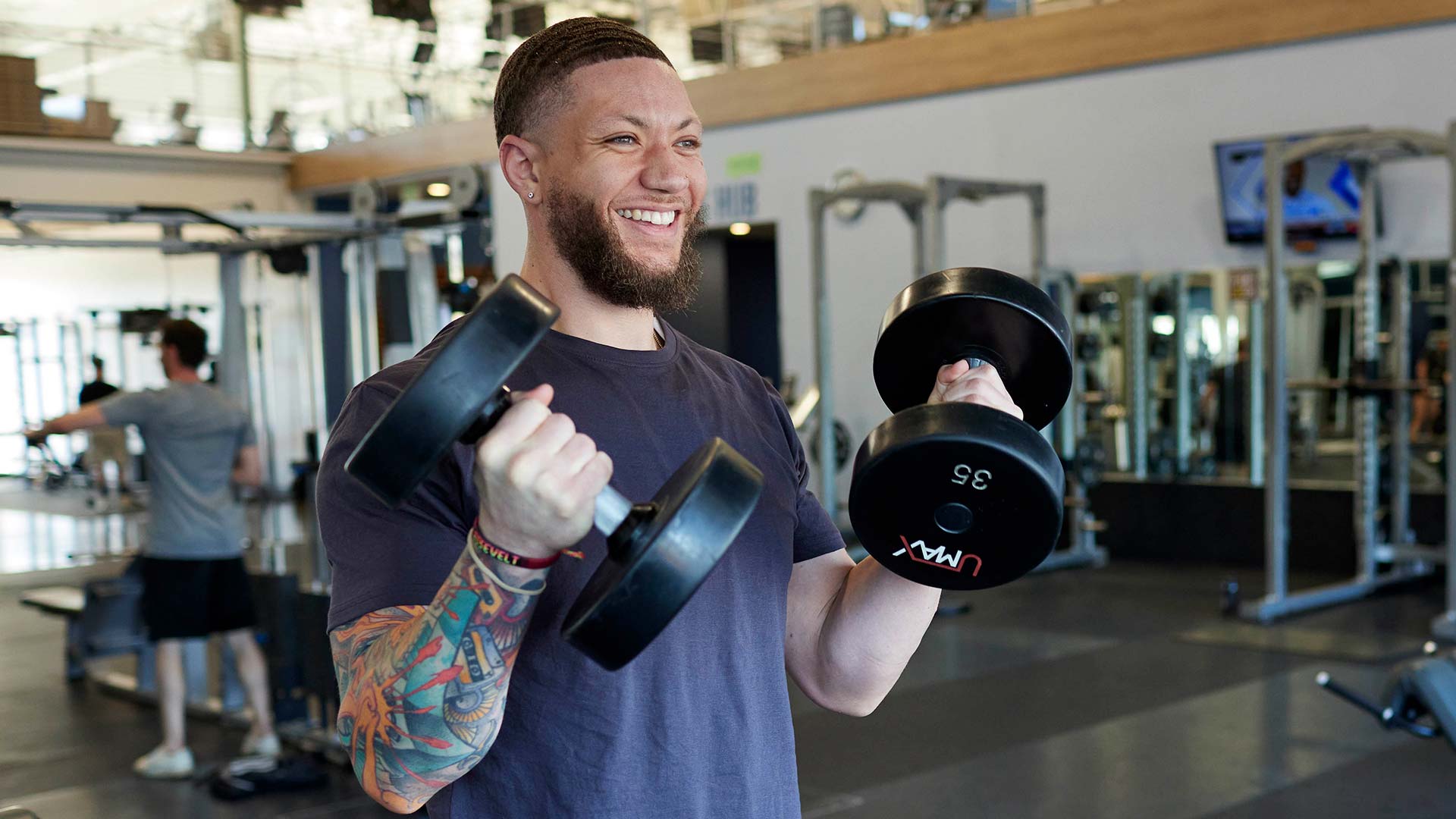 man lifting dumbells in a bicep curl