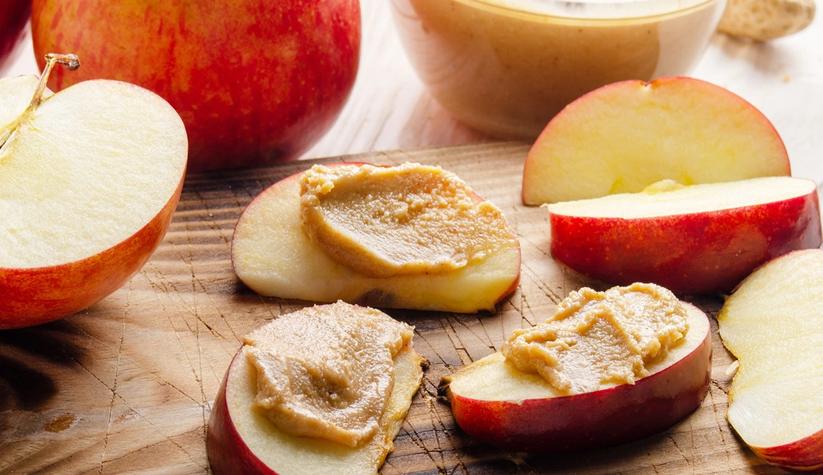 Apple Slices and Almond Butter on a cutting board