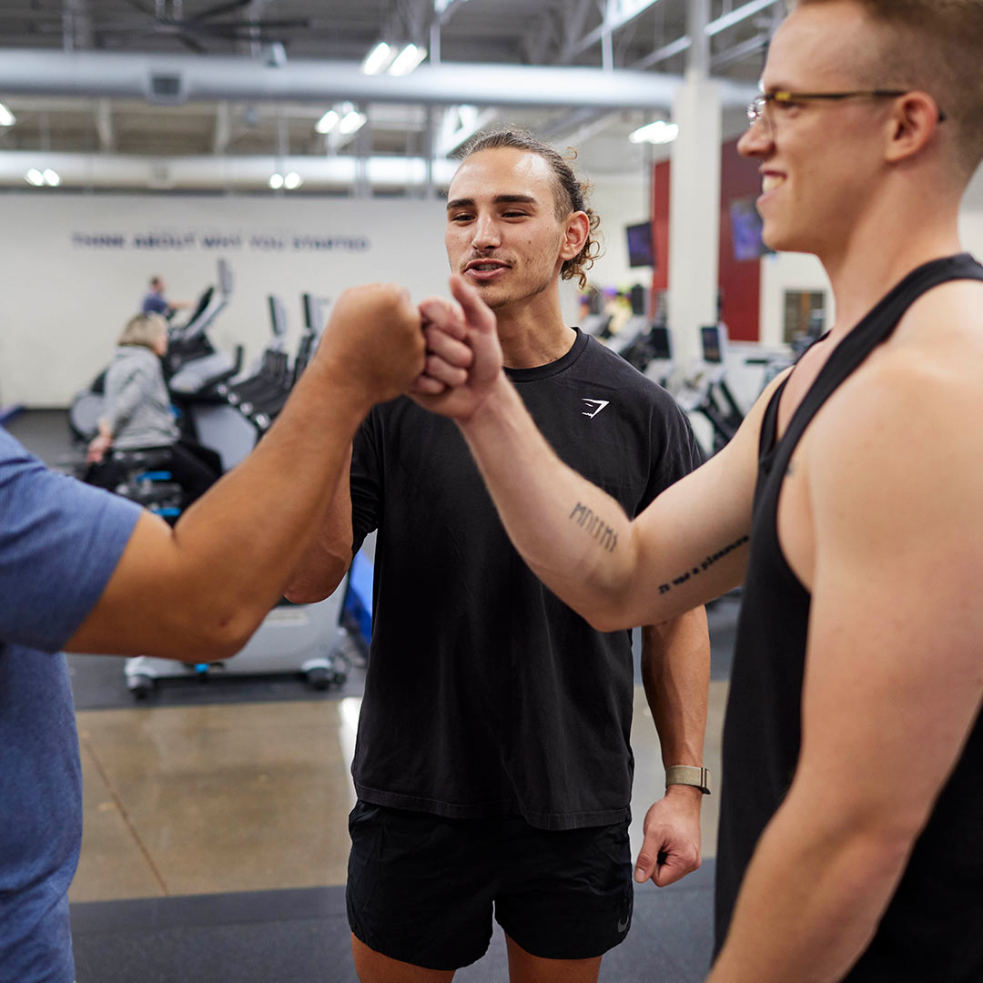 Men hanging out between sets at gym