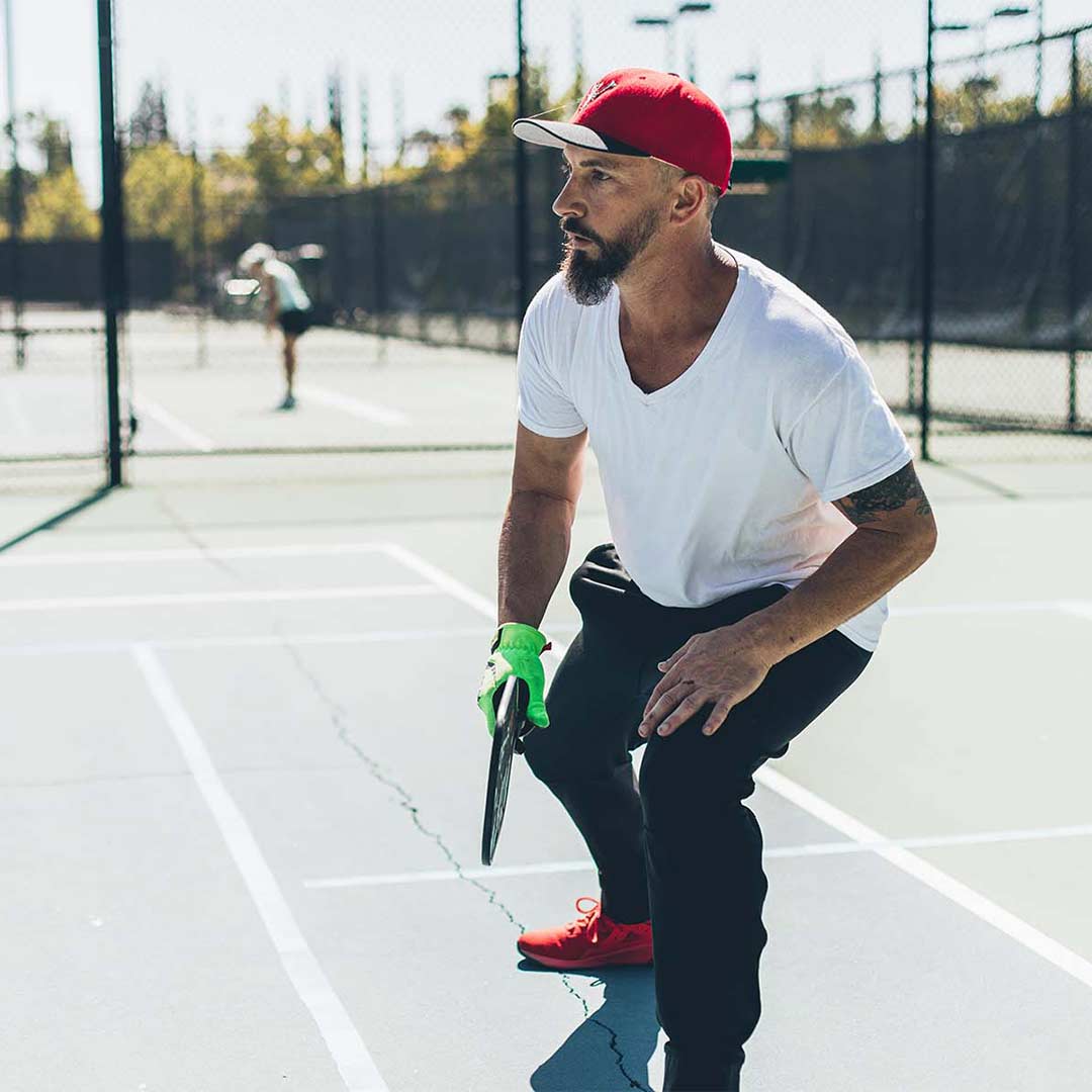 Man playing pickleball outdoors