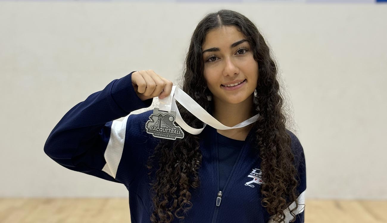 Girl smiling and holding award medal