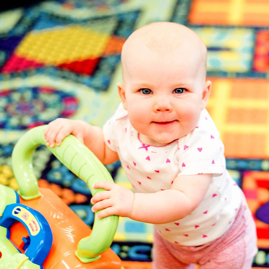 Infant playing with toy